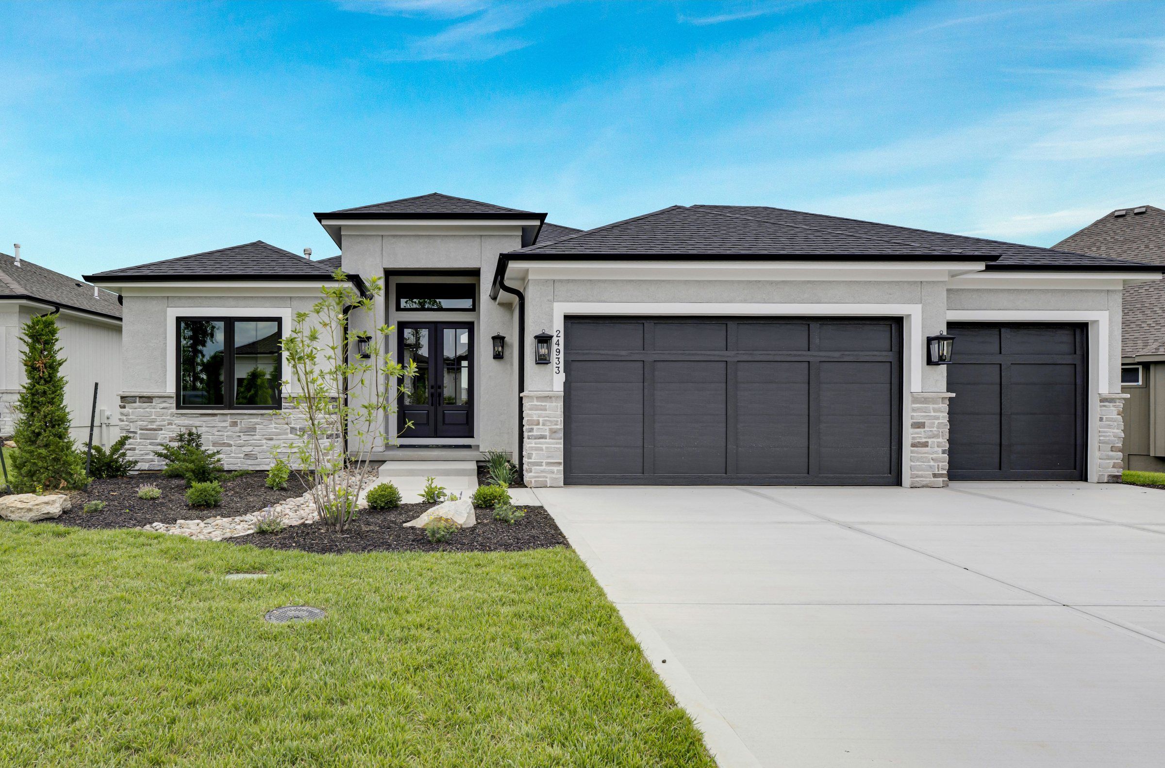 White ranch-style JFE Construction home with a three-car garage in Canyon Creek Forest, Lenexa, Kansas