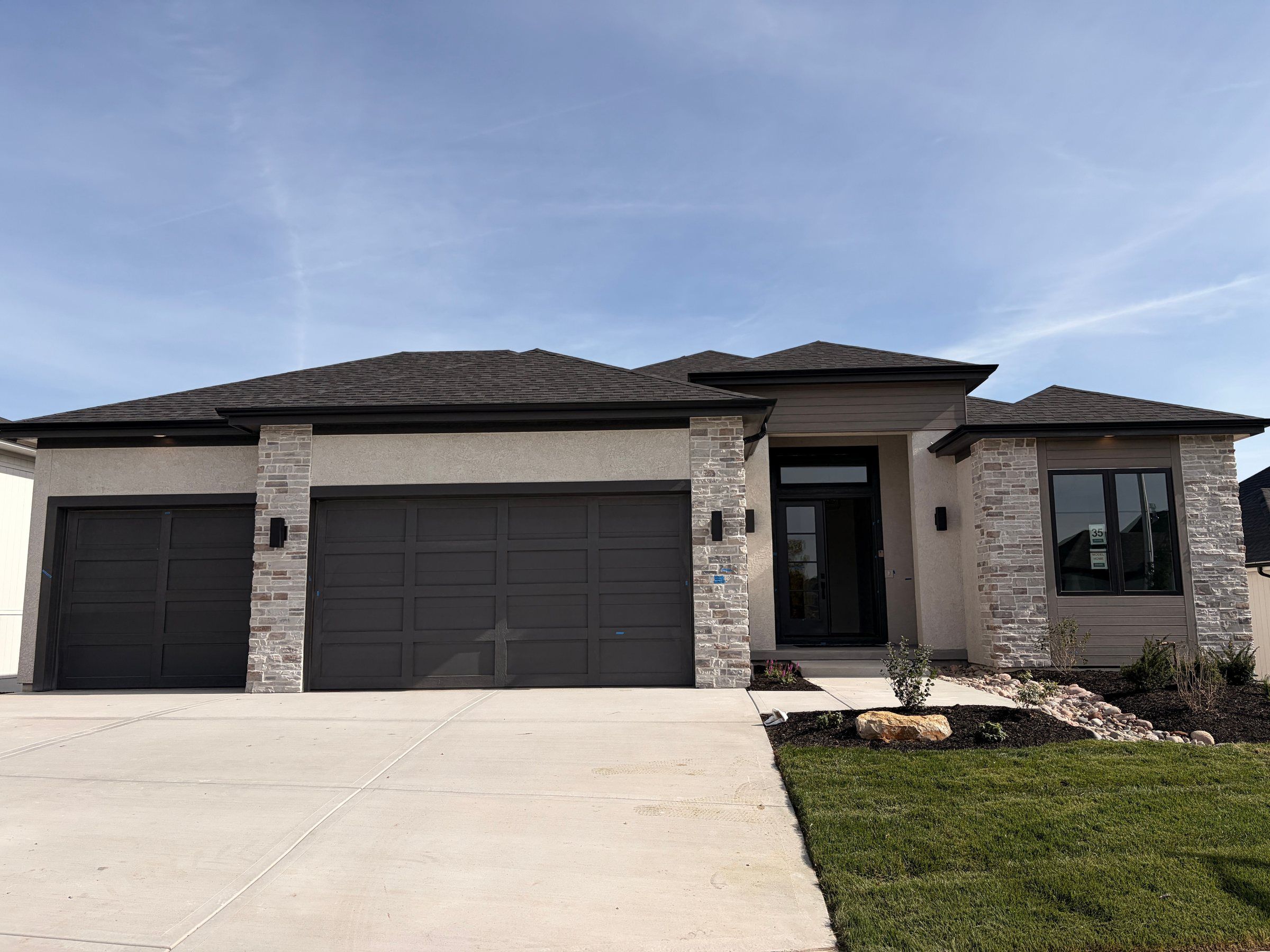 Stone and stucco Bayberry Expanded model home by JFE Construction in Prairie Canyon, Olathe
