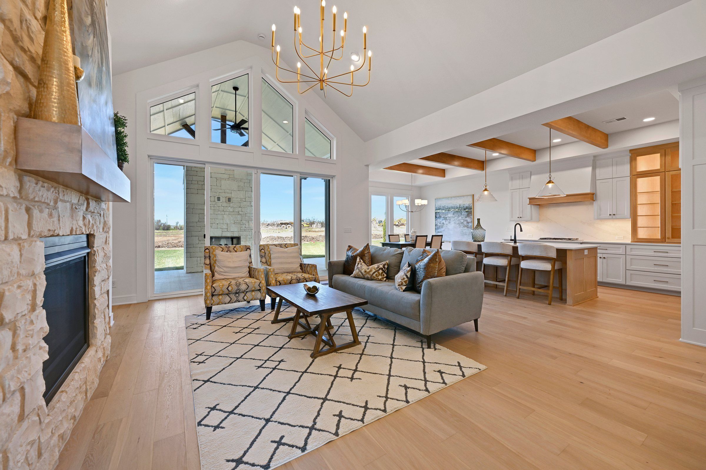 Vaulted great room with a stone fireplace in the JFE Bayberry I model, Heritage Ranch