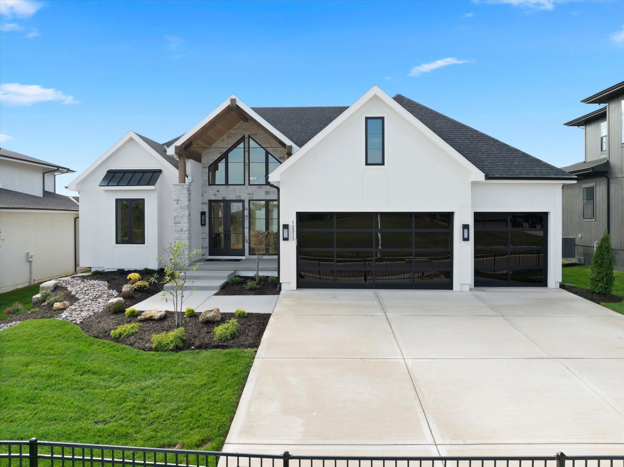 White modern farmhouse Gunnison V model home by JFE Construction in Riverstone Valley, Overland Park