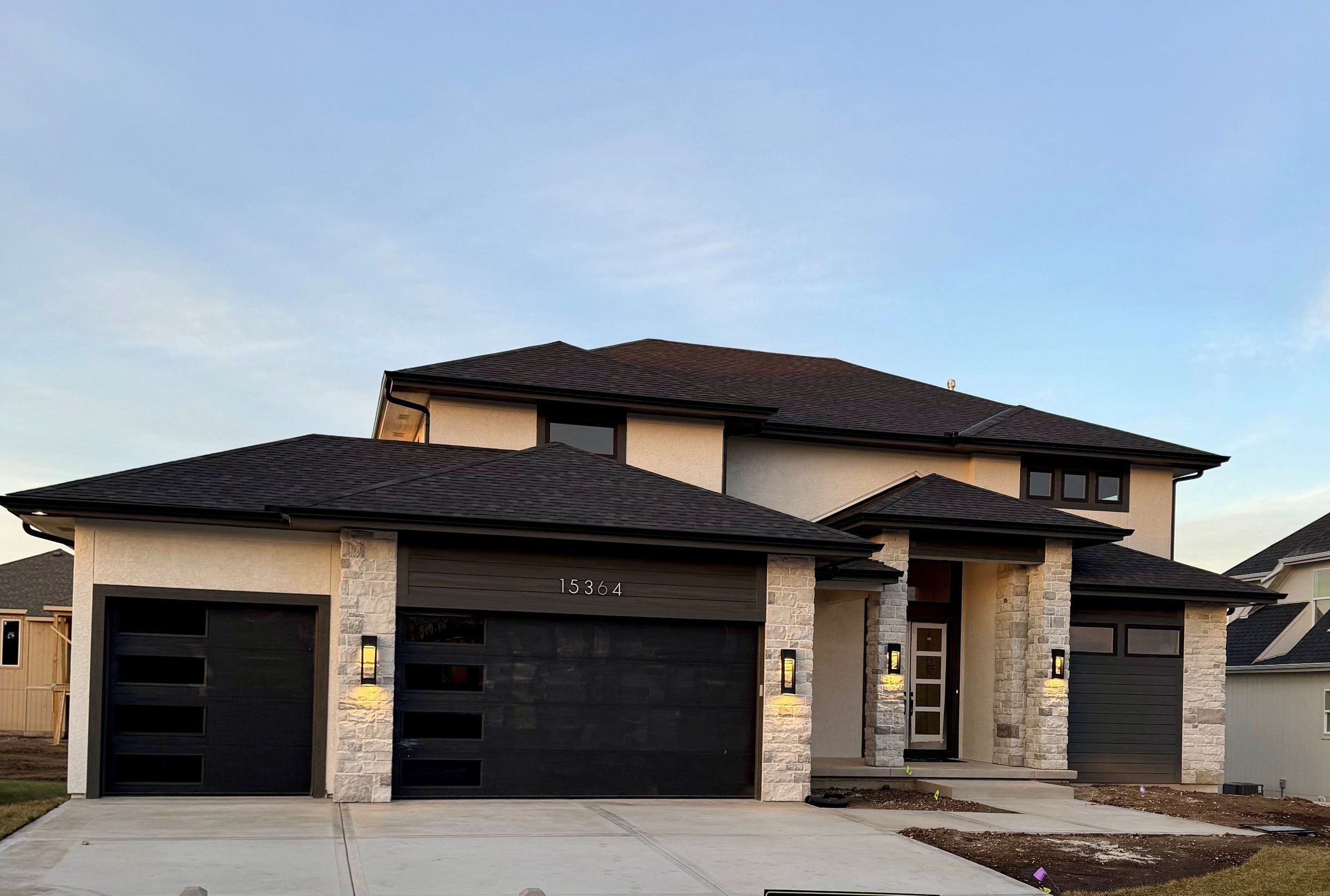Contemporary two-story Modern Woodland model home by JFE Construction at dusk, Heritage Ranch