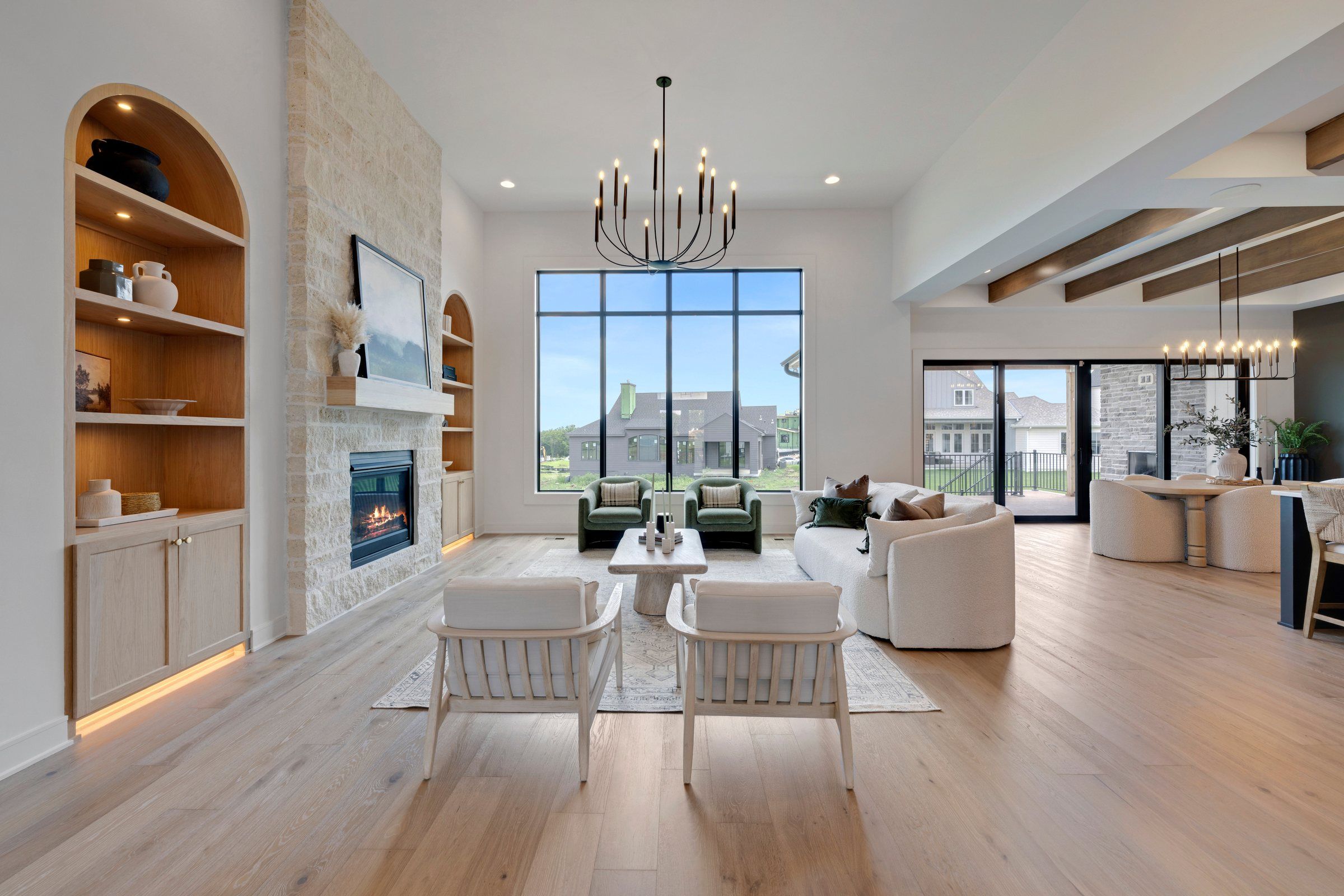 Great room with arched built-ins and a window wall in the JFE Construction Woodmyre model, Overland Park